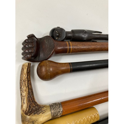 161 - A group of walking sticks / canes some with interesting finials including a carved horse head, a sna... 