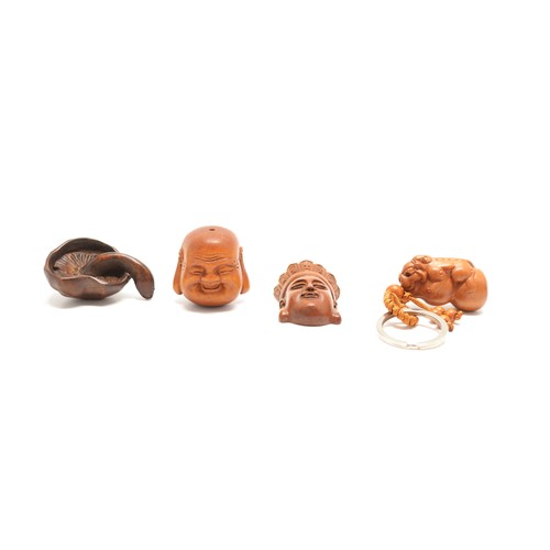 168 - x 4 hardwood Netsukes, a signed Buddha's head, a flat-backed Buddha's head, a Key Ring with a Dragon... 