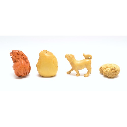 169 - x 3 lightwood and 1 amber-coloured Netsuke -  to include a signed Buddha's Head, a dog, a Dragon and... 