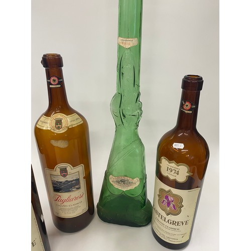 172 - Oversized vintage wine bottles (x3) plus a large green glass bottle in the form of a rifle. Ideal fo... 