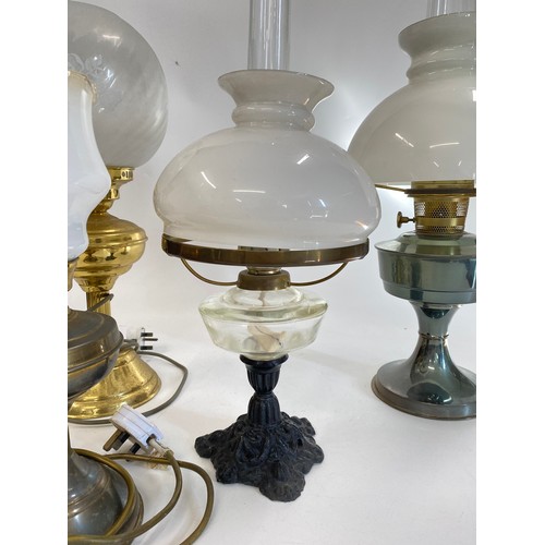 218 - Vintage lamps x4 to include 2 oil lamps complete with shades & Funnels  and 2 brass effect lamps con... 