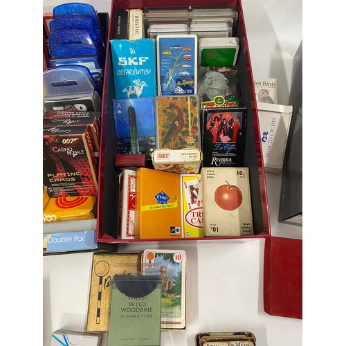 242 - A large quantity of collectable vintage and early 20th Century playing cards and card games includin... 