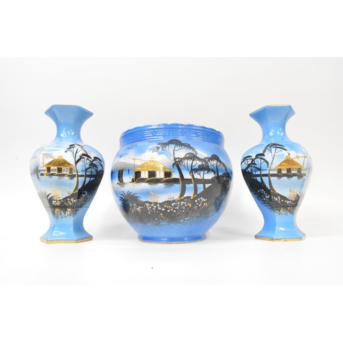 18 - Oriental themed pottery with gilding consisting pair of vases and jardinere