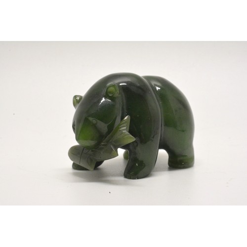 39 - A small carved bear holding a fish. L 5cm (approx)