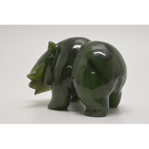 39 - A small carved bear holding a fish. L 5cm (approx)