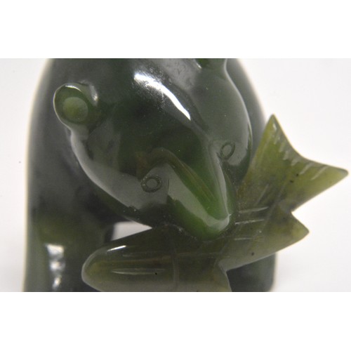 39 - A small carved bear holding a fish. L 5cm (approx)