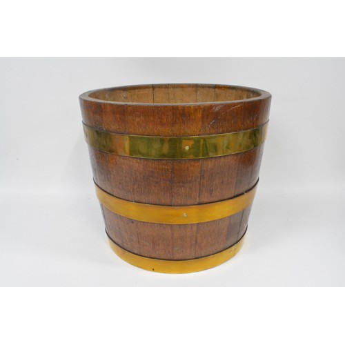 92 - A vintage triple brass banded half barrel coal/log bucket. approx height 36 cms