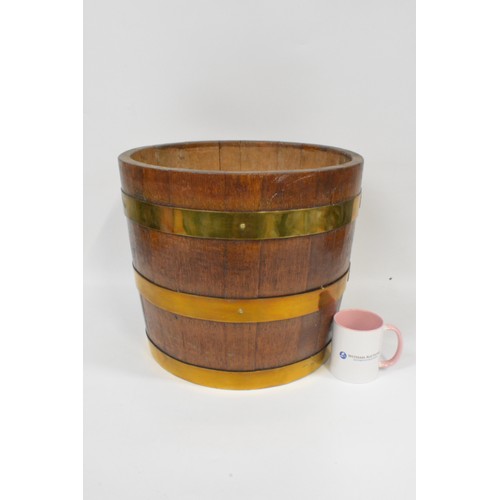 92 - A vintage triple brass banded half barrel coal/log bucket. approx height 36 cms