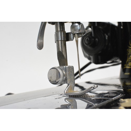 119 - Vintage cased Electric Singer sewing machine with pedal , working at time of cataloguing and has a  ... 