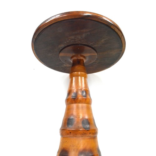 141 - Brazilian monkey puzzle tree wood, butterfly/moth wing occasional table, the circular top with an ar... 