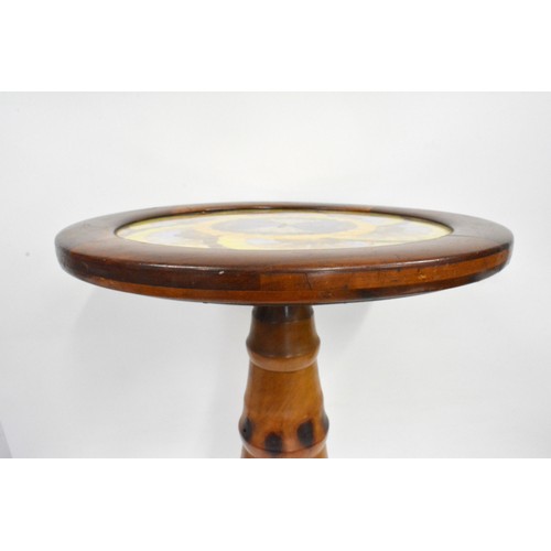 141 - Brazilian monkey puzzle tree wood, butterfly/moth wing occasional table, the circular top with an ar... 