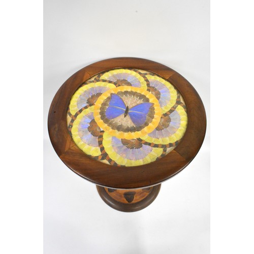 141 - Brazilian monkey puzzle tree wood, butterfly/moth wing occasional table, the circular top with an ar... 