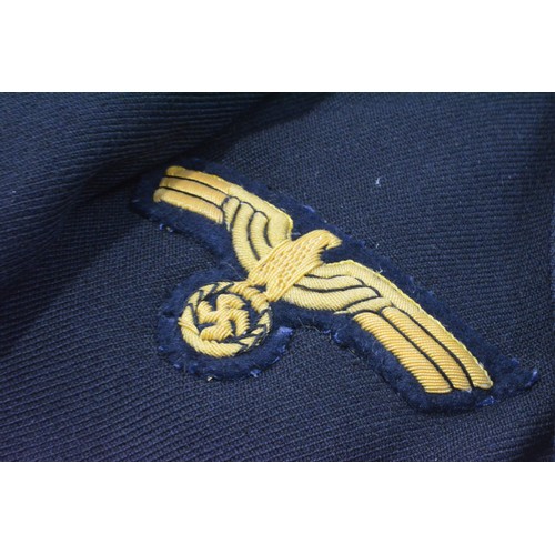 256 - WW2 German clothing items consisting; Kriegsmarine Leiutenant's blue tunic complete with insignia br... 