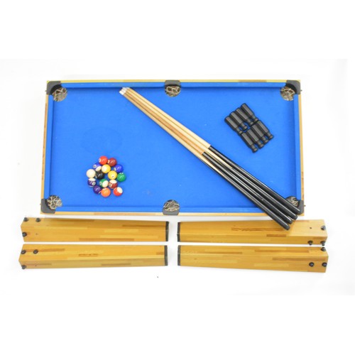 269 - Modern children's pool table. Veneered pine with a blue baize and detachable legs, measuring 44