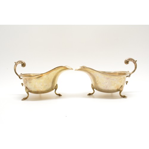 278 - A pair of antique silver sauce boats, both on three pad feet with beaded rim, Hallmarked Birmingham,... 