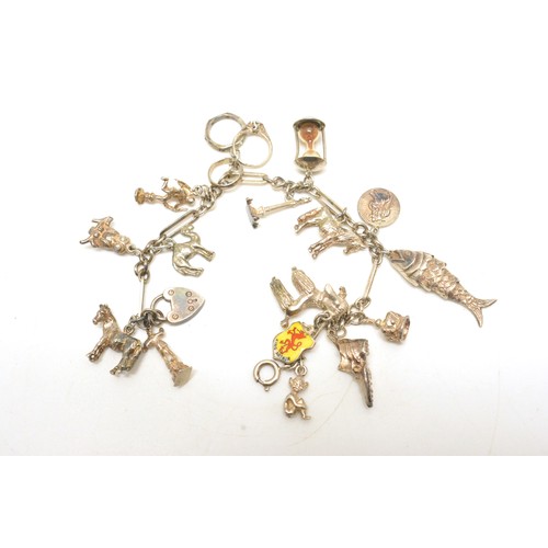 331 - Vintage hallmarked silver charm bracelet with 16 charms, together with £10 shillings note encased in... 