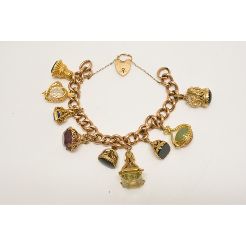 363 - 9ct gold charm bracelet with various substantial fob charms which are all gold, padlock hallmarked 9... 