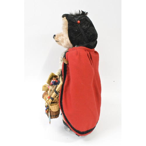 50 - Beardwell blonde fur Christmas dressed bear on stand, selling wares,  approx. size 42 cms [16