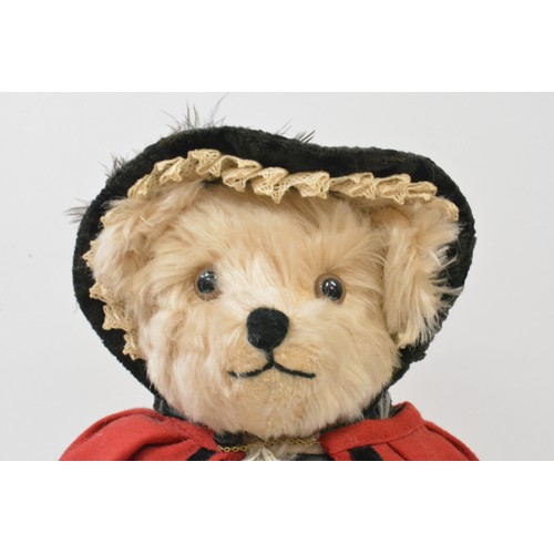 50 - Beardwell blonde fur Christmas dressed bear on stand, selling wares,  approx. size 42 cms [16