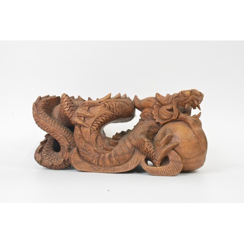 106 - Hand carved Chinese dragon figure, approx L31cm