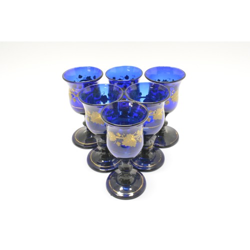 273 - Cobalt blue glasses (x6) with gilded vine decoration together with Georgian Bristol blue 'soy' condi... 