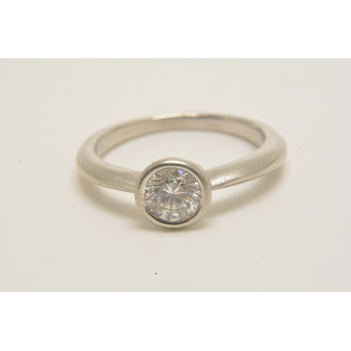 313 - Platinum solitaire ring set with a round brilliant cut diamond in a rub over setting, diamond weight... 