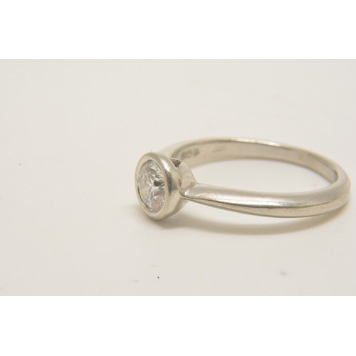 313 - Platinum solitaire ring set with a round brilliant cut diamond in a rub over setting, diamond weight... 