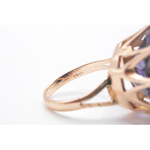 315 - Yellow gold ring, with large amethyst round cut stone in raised  mount.  stamped 14K, Approx height ... 