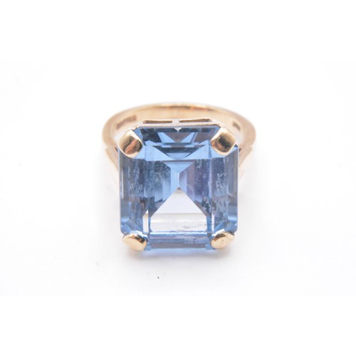 316 - 9ct yellow gold ring with emerald cut large blue stone in raised mount,  hallmarked London, approx s... 