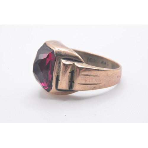 320 - Gold ring stamped 10k R&S with raised gallery design, red faceted stone, approx size M/N. approx gro... 