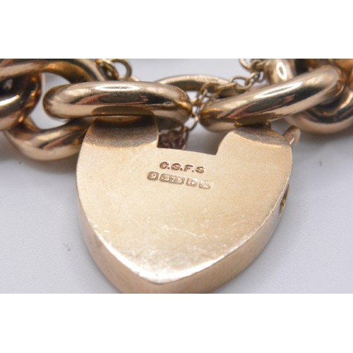 333 - 9ct gold link bracelet with padlock clasp, with attached x4 gold coins/fob charm - all links and cla... 