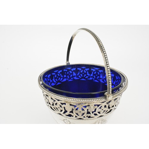 247 - Antique Silver sugar basket with blue liner.  Pierced foliate design with swags and bow engraving, h... 