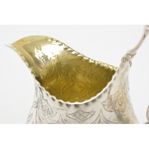 250 - Antique Silver gilt jug with engraved flower/foliate design, hallmarked London poss.c.1783. marks wo... 