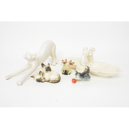 17 - Cat themed items consisting of a vintage Beswick figure of two Siamese cats snuggling, a Goebel kitt... 