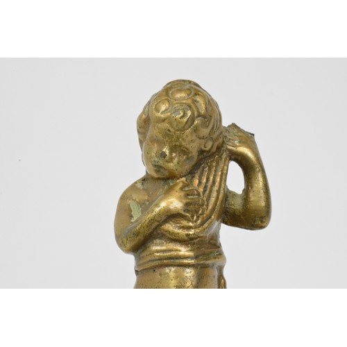 27 - Bronzed and slate figurine of cherub guarded by winged dragons, height 24cms