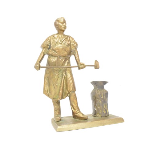 41 - Vintage heavy cast figure of blacksmith at his anvil together with a Copper tea kettle, 26cms tall