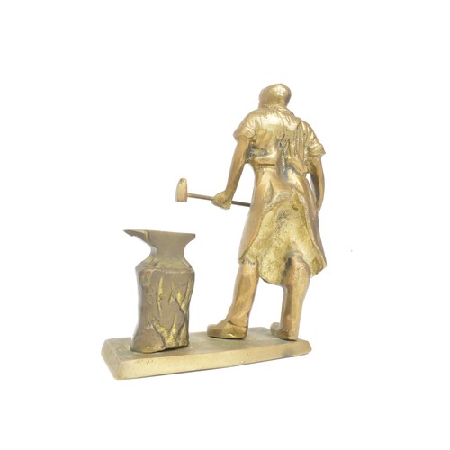 41 - Vintage heavy cast figure of blacksmith at his anvil together with a Copper tea kettle, 26cms tall