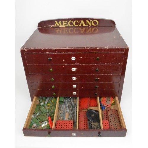 82 - Early Meccano 6 drawer cabinet  containing a large quantity of accessories and stickers and mixed in... 