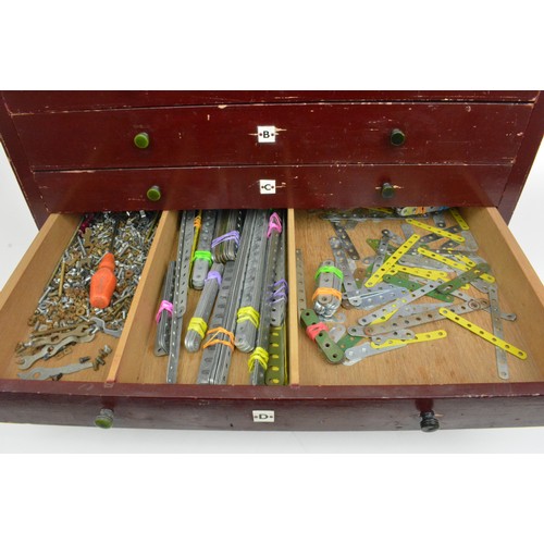 82 - Early Meccano 6 drawer cabinet  containing a large quantity of accessories and stickers and mixed in... 