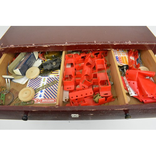 82 - Early Meccano 6 drawer cabinet  containing a large quantity of accessories and stickers and mixed in... 