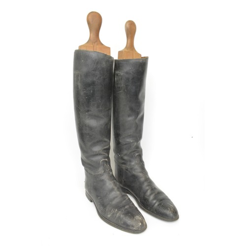 117 - Three pairs of leather rider's boots, one with spurs and wooden boot stretchers. All Sale proceeds a... 