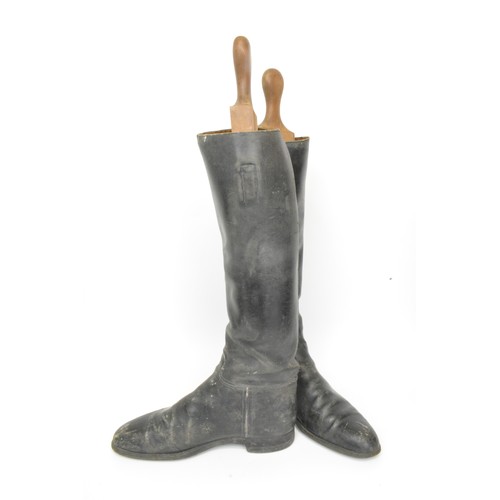 117 - Three pairs of leather rider's boots, one with spurs and wooden boot stretchers. All Sale proceeds a... 