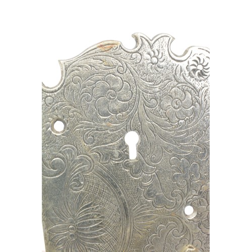 139 - A pair of white metal wardrobe plates with decorative foliate designs, swastika style handles, belie... 