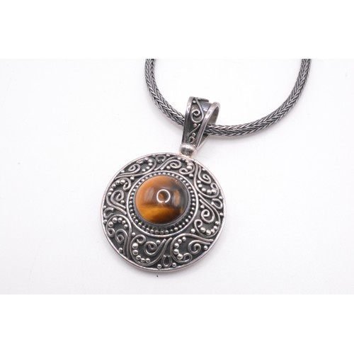 160 - Tigers Eye pendant stamped Suarti 925 on silver chain hallmarked silver, approx gross weight 33g.