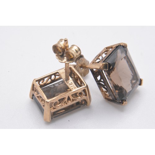 165 - Smokey quartz jewellery items consisting ring (size P) hallmarked Birmingham 375., earrings, pendant... 