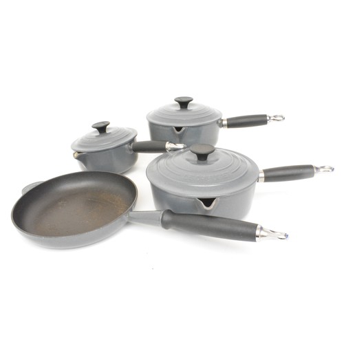 45 - Le Creuset saucepan set, with pan, heavy cast iron enamel, finished in grey/cream.