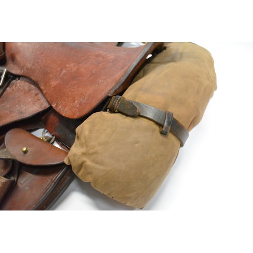 110 - H Woolley & Sons of Uttoxer military style brown leather saddle complete with saddle bags and brass ... 