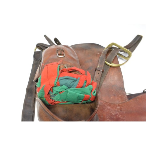 110 - H Woolley & Sons of Uttoxer military style brown leather saddle complete with saddle bags and brass ... 