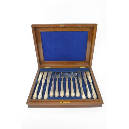 A Victorian silver cased fish service for 12 persons by Sheffield silversmith Martin Hall and Co, c.1892. Knife blades with foliate detailing, handles all engraved with matching crest to top of two tier box, approx 1.327kg