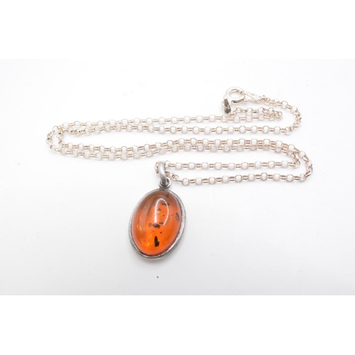 240 - 925, Italy, Silver necklace with two amber pendants one oval shaped, other graduating ambers on an 1... 